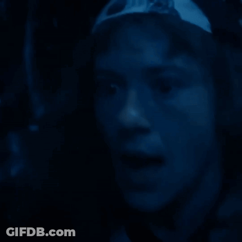 Close Up Face In Dark Room Blue Background GIF