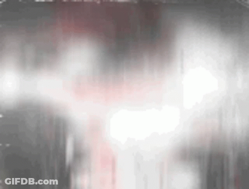 Close-Up Face In Dark Room With Smoke GIF