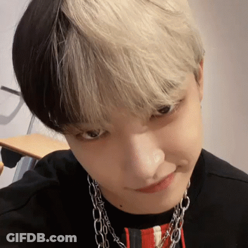 Close Up Face With Black And White Hair And Necklace GIF