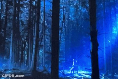 Close-Up Face With Blue Lights In Dark Room GIF