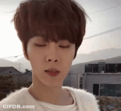 Close Up Face With Eyes Closed And Building Background GIF