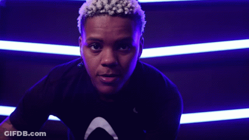 Close Up Face With Purple Lights Behind GIF