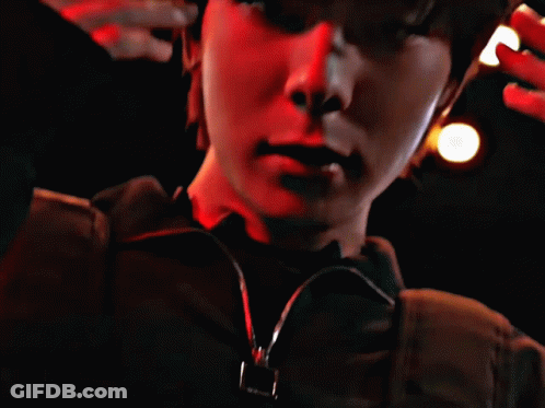 Close Up Face With Red Lights Behind GIF