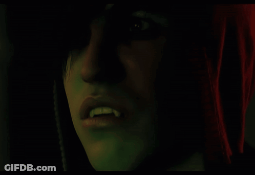 Close Up Face With Vampire Teeth GIF