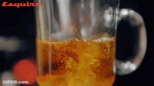 Close Up Glass With Esquire On Bottom GIF