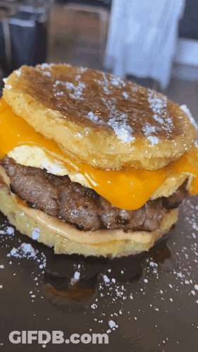 Close Up Hamburger With Cheese And Eggs On Pancake GIF