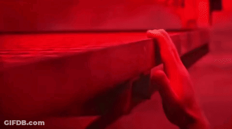 Close-Up Hand On Table In Red Light GIF