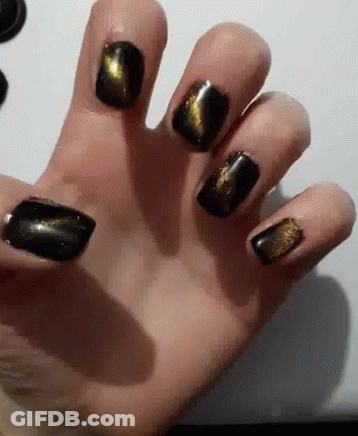 Close Up Hand With Black And Gold Nail Polish GIF