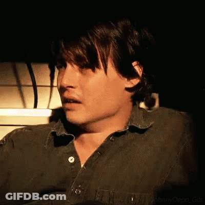 Close Up Man In Green Shirt Dark Room GIF