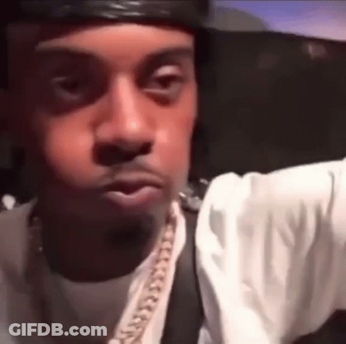 Close Up Man's Face With Hat And Chain GIF