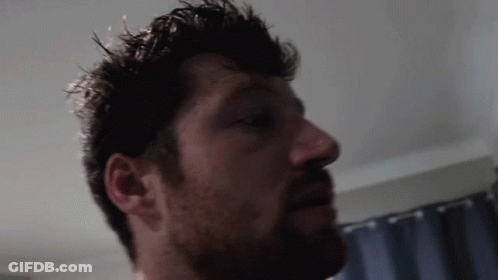 Close Up Man With Beard And Blue Curtain GIF