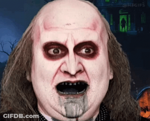 Close Up Man With Blood Coming Out Of Mouth In Front Of Haunted House GIF