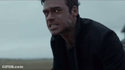 Close Up Man With Glowing Eyes In Field GIF