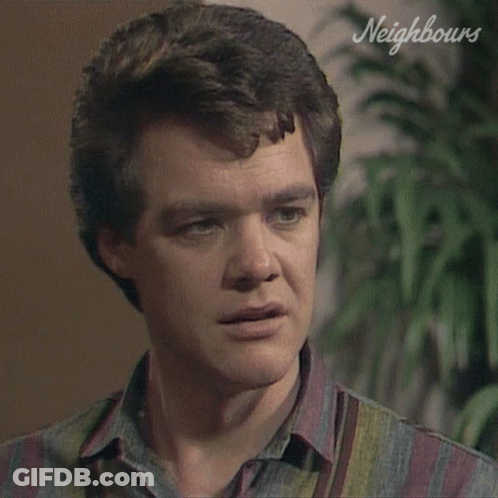Close Up Man With Neighbours Written On Wall GIF