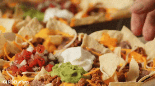 Close Up Nachos With Guacamole, Sour Cream, And Cheese GIF