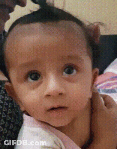 Close Up Of Baby Face Held By Woman GIF