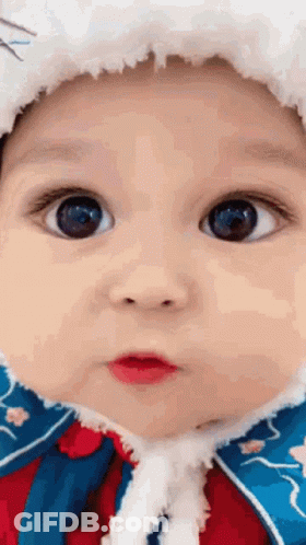 Close Up Of Baby Face Wearing Hat And Coat GIF