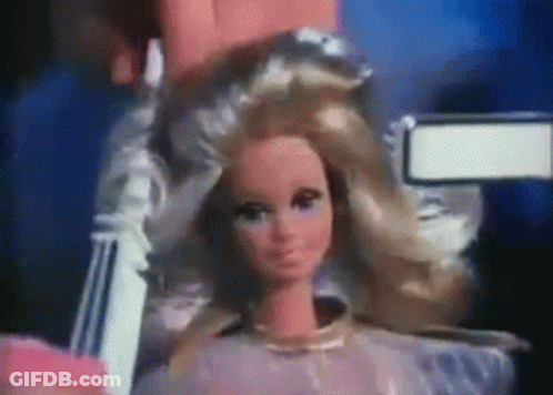 Close Up Of Barbie Doll Being Held GIF