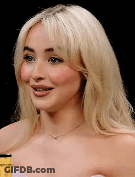 Close Up Of Blonde Woman Wearing Necklace And Strapless Dress GIF