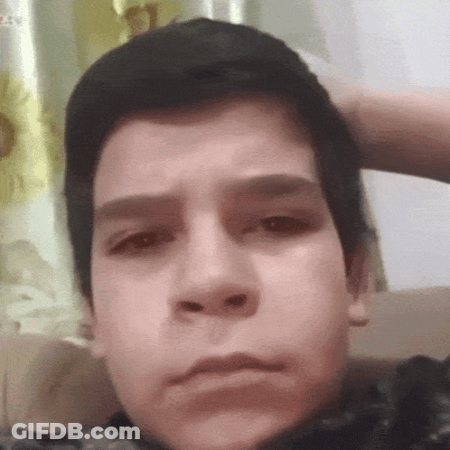 Close Up Of Boy With Hand On Head GIF