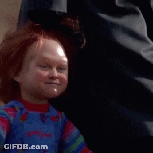 Close-Up Of Child's Doll With Red Hair And Overalls GIF