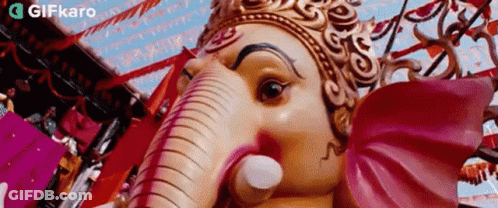 Close Up Of Crowned Deity Statue GIF
