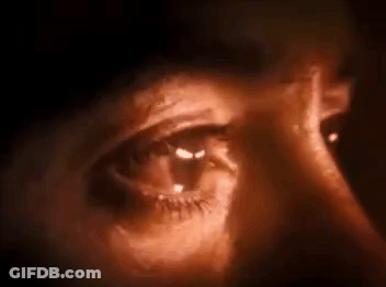 Close Up Of Eye With Light Shining Through In Dark Room GIF