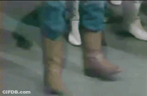 Close Up Of Feet In Brown Boots GIF