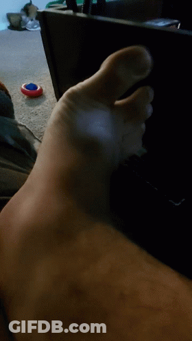Close Up Of Foot With Red White Blue Object GIF