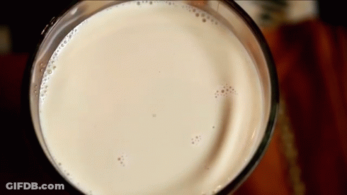 Close Up Of Glass Of Milk With Bubbles GIF
