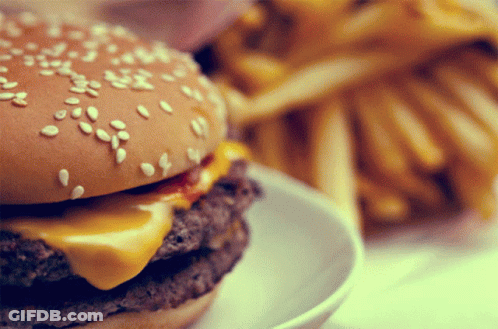 Close Up Of Hamburger With Sesame Seeds And French Fries GIF