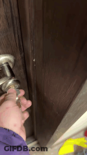 Close Up Of Hand Holding Door Handle GIF
