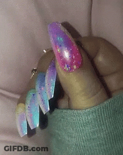 Close-Up Of Hand With Blue Nails And Silver Glitter GIF