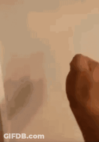 Close Up Of Hand With Shadow On Wall GIF