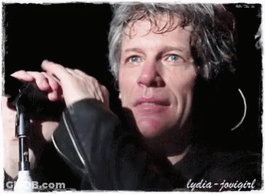 Close Up Of Man Holding Microphone With Lydia GIF