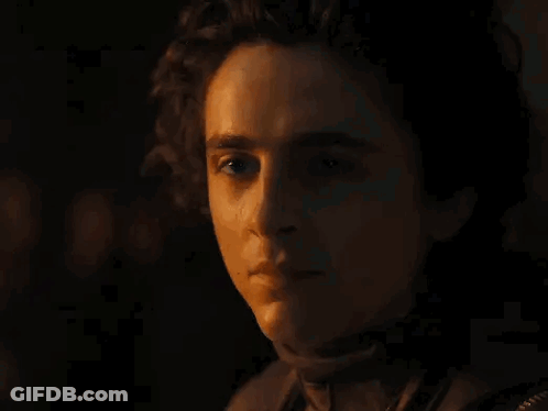 Close-Up Of Man Holding Stick In Dark Room GIF