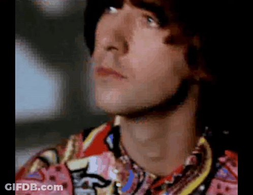 Close Up Of Man In Colorful Shirt Looking Up GIF