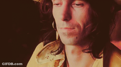 Close Up Of Man In Hat And Earrings Looking At Camera GIF