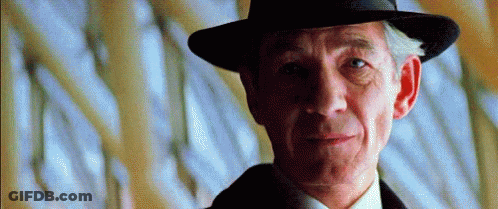 Close Up Of Man In Hat And Suit GIF