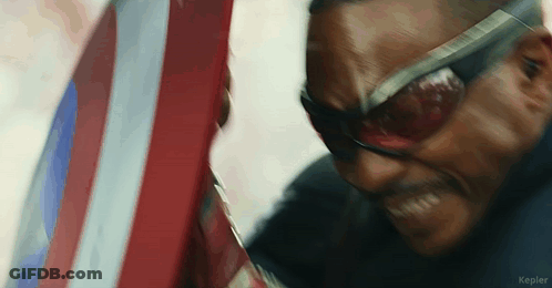 Close Up Of Man In Sunglasses Holding Shield GIF