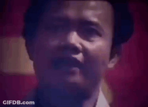 Close Up Of Man's Face Against Red Background GIF