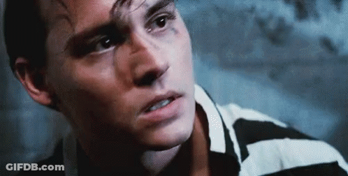 Close Up Of Man's Face In Black And White Striped Shirt GIF