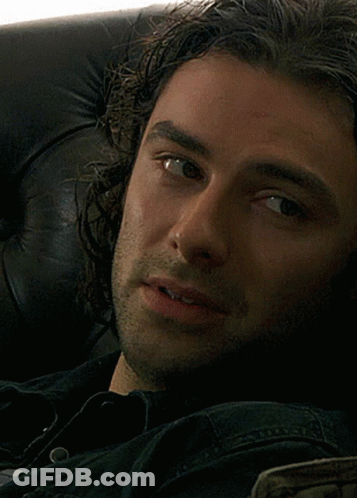 Close Up Of Man's Face In Black Shirt GIF