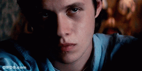 Close Up Of Man's Face In Dark Room GIF
