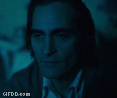 Close Up Of Man's Face In Dark With Blue Background GIF