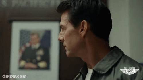 Close Up Of Man's Face In Front Of Top Gun Maverick GIF