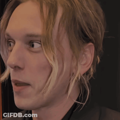 Close Up Of Man's Face On Black Background GIF