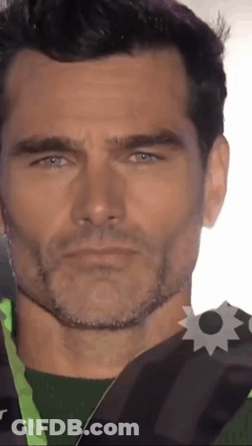 Close Up Of Man's Face With Badge GIF