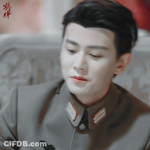 Close Up Of Man's Face With Chinese Writing GIF