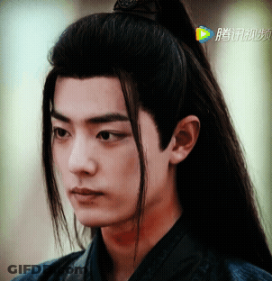 Close Up Of Man's Face With Chinese Writing GIF